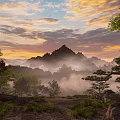 Stunning Sunset Landscape With Misty Mountains Green Trees And Colorful Clouds