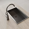 Stainless Steel Kitchen Sink Built In Light Colored Countertop With Curved Faucet