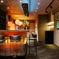 Modern Bar Interior Design With Sleek Counter Black Stools And Warm Ambient Lighting