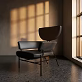 Modern Leather Accent Chair In Sunlight Through Window With Light Shadows On Concrete Floor
