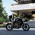 Stylish Motorcycle With Silver Haired Woman In Black Outfit Near Modern House And Green Plants