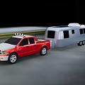 Red Pickup Truck Utility Vehicle Towing Silver Camper Trailer on Road