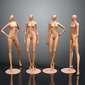 Four Gold Female Mannequins in Different Poses on Round Bases Against Gray Background