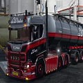 Red And Gray Heavy Truck With Tank Trailer At Industrial Site