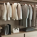 Stylish Hanging White Gray Coats And Outerwear On Display Rack With Bags