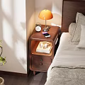Bedside Table With Orange Lamp Alarm Clock Mobile Phone Books Cups And Drawer In Bedroom