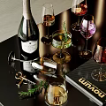Sophisticated Champagne Bottle And Wine Glasses With Colored Wines Rosemary Garnish And Corkscrew