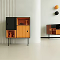 Modern Black and Orange Storage Chest of Drawers with Thin Legs and Vertical Striped Wall