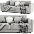 Cozy Two Seater Sofa with Plush Pillows and Checkered Blanket Accents
