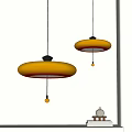 Modern Yellow Round Pendant Lights Hanging in Room with Light Colored Wall and Decorative Ornament
