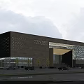 Modern Museum Building With Beige Stone Perforated Facade Glass Curtain Wall And Grand Entrance