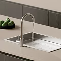 Stainless Steel Kitchen Sink With Silver Faucet Green Fruits On Counter