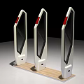 White Public Facility Turnstiles With Transparent Glass Panels Red Barriers And Wooden Base