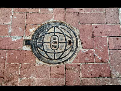 Traditional Manhole Cover On Red Brick Pavement With Intricate Circular Design 3d model