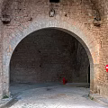 Stone Archway With Stone Walls Cobblestone Path Red No Entry Sign And Red Fire Hydrant