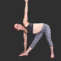 Woman practicing yoga in black sports bra and patterned leggings with raised arm in side bend
