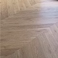 Light Brown Hardwood Flooring With Herringbone Pattern And Natural Texture