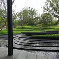 Lush Garden Landscape With Stepped Water Pool Green Plants And Surrounding Trees
