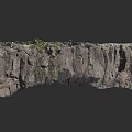 Aerial View Of Rocky Cliff With Lush Vegetation On Mountain Terrain