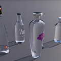Collection of Transparent Liquor Bottles with Various Labels on Gray Background