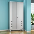 Silver Double Door Storage Cabinet In Light Blue Room With Green Plant And Blinds