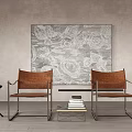 Brown Leather Chairs And Small Coffee Table Against Patterned Painting On Wooden Floor