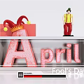 April Fool's Day Festive Display With Jester Figure Red Gift Box And Glittery April Lettering