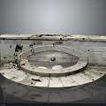 Weathered Stone Circular Basin Structure with Central Sphere and Scattered Cracked Fragments