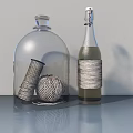 Transparent Glass Dome Wine Bottles With Spool Yarn Ball And Twine Wrapped Design On Table