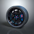 Car Wheel Tire Design With Black Rim Blue Accents And Red Center Logo