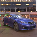 Blue Lexus Sports Sedan On Urban Street With Evening City Lights And Modern Buildings