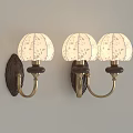 Elegant Three Wall Lamps With White Floral Shades Dark Bases And Brass Arms On Wall