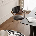 Modern Black Leather Dining Chair With Wooden Armrests And Metal Legs In Bright Dining Area