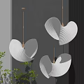 Modern Interior Space With Three White Scalloped Pendant Lights Emitting Warm Glow And Green Plants