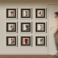 Gallery Wall Featuring Nine Framed Sculpture Heads In Different Colors With Person Walking By Indoor