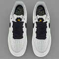 White Nike Sneakers With Black Laces And Small Yellow Flower On Tongue