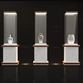 Modern Display Cabinets With Glass Doors And Marble Bases Showcasing Decorative Vases