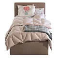 Cozy Single Bed with Green Quilt Pink Comforter Decorative Pillows and Wooden Headboard