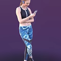 Woman in CrossFit Athletic Tank Top Wearing Blue Workout Leggings Holding Smartphone and Earphones