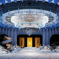 Modern Blue Banquet Hall With Large Crystal Chandelier Central Stage Dining Tables And Elegant Decorations