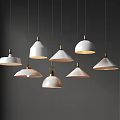 Multiple Modern White Chandeliers With Gold Accents Hanging In Stylish Design