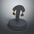 Elegant Jewelry Display Rack Featuring Golden Heart Shaped Earrings On Gray Base