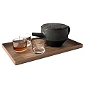Modern Tea Set with Black Teapot and Glass Cups on Wooden Tray