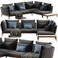 Gray Sectional Sofa With Blue Pillows Throw Blanket And Wooden Legs