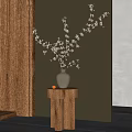Light Gray Vase With White Blossom Branches On Wooden Cylindrical Stand Against Wooden Wall