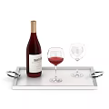 Wine Bottle with Red Wine and Two Glasses on Silver Tray with Decorative Rings