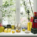 Decorative Ornament Set on Window Sill with Colorful Gift Boxes Teacups Plates and Green Plants