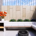 Modern Courtyard Garden with Fire Pit Stepped Seating Lush Greenery Red Blooms and Glass Railings