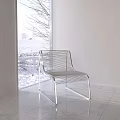 Modern Leisure Chairs with Metal Frame and Hollow Design in Interior with Snowy Window View