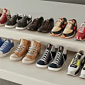 Various Shoes In Different Styles And Colors Neatly Arranged On White Multi Tiered Shelves